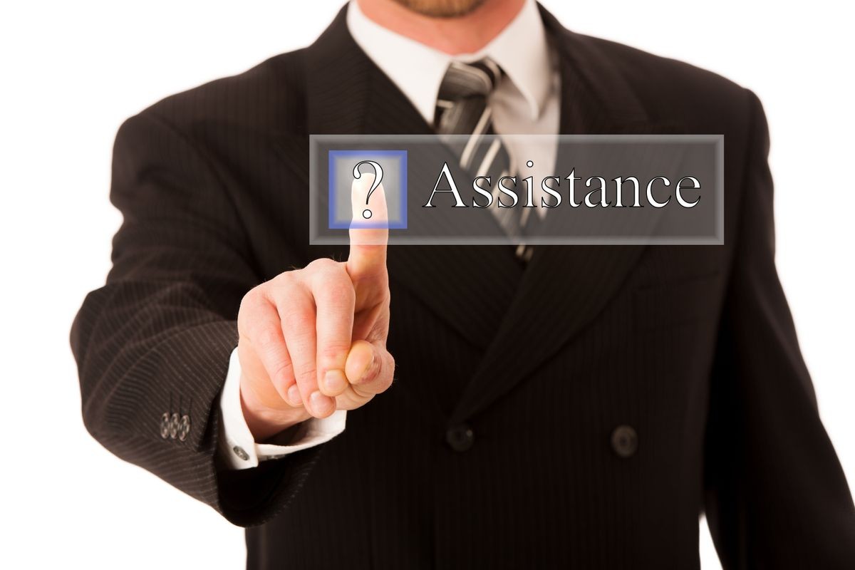 Happy young businessman in suit and tie pressing virtual button assistance - customer service conceptual